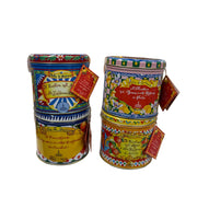 Two decorative tins with colorful labels in a store setting