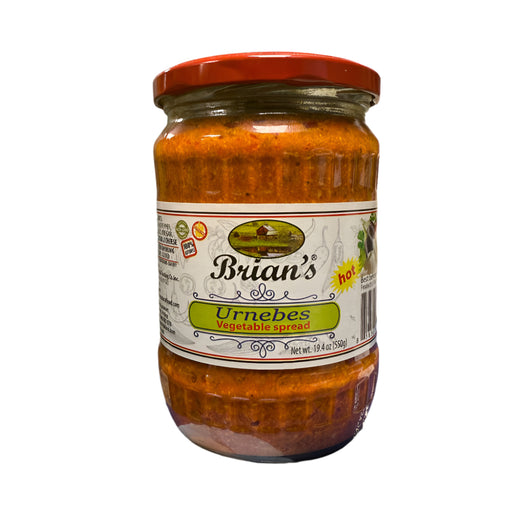 Jar of Brian's Urmebes Vegetable Spread on a blue surface with a tiled wall background