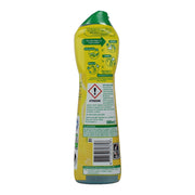 A 500ml bottle of dishwashing liquid shown from the back, featuring a bright yellow label with green accents, a green cap, and a red hazard warning symbol.