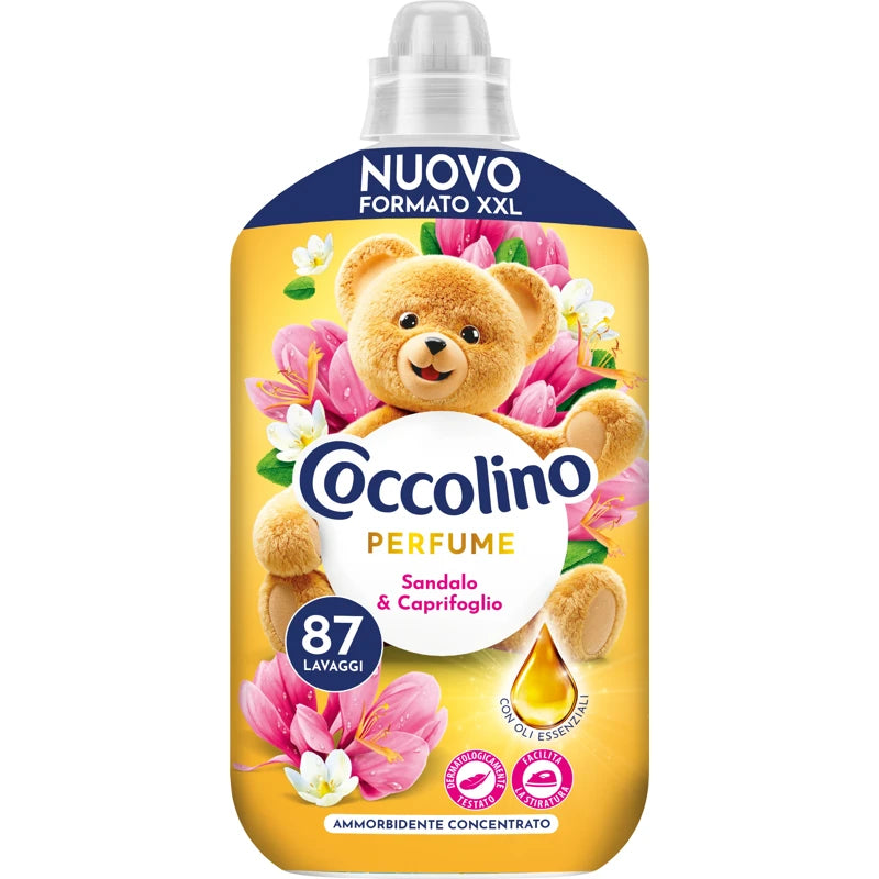 Coccolino perfume bottle with teddy bear and flowers on a yellow background