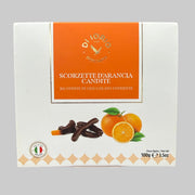 Box of Scorzette d'Arancia Candite held in front of a store shelf.