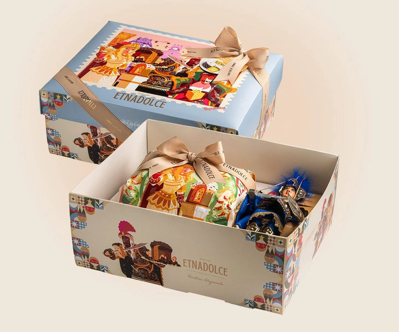 Etna Dolce gift box with colorful packaging and a bow on a beige background