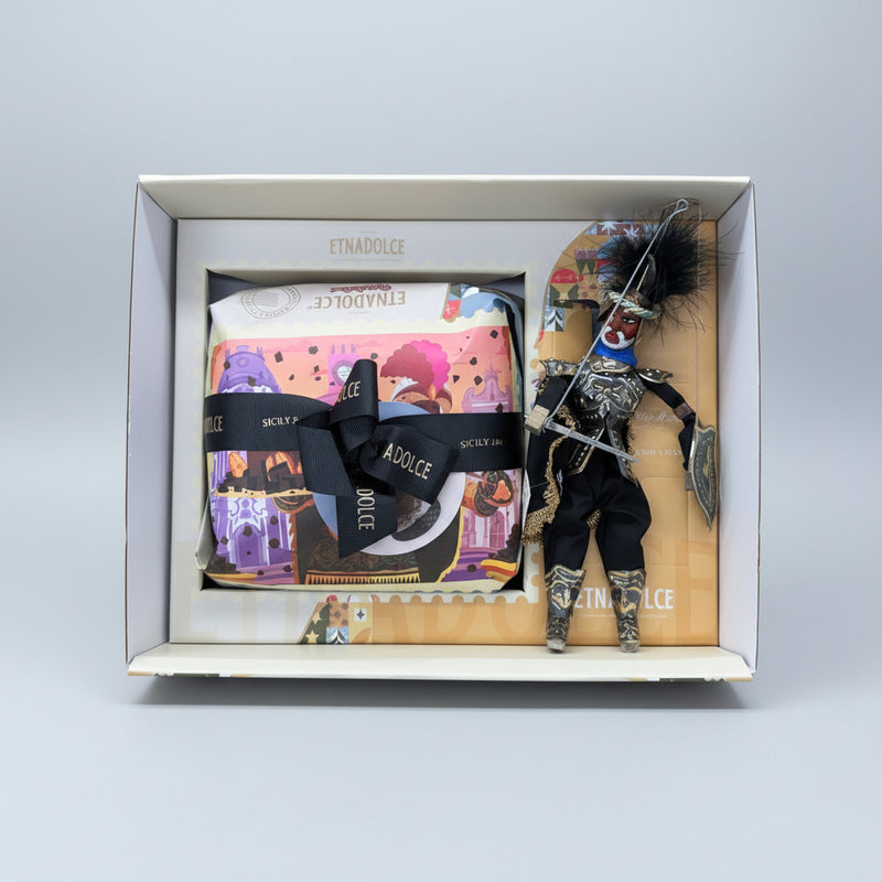 Gift box with branded items and a figurine in a store setting