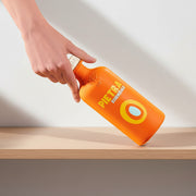 Orange bottle with 'Pietra' branding on a yellow background