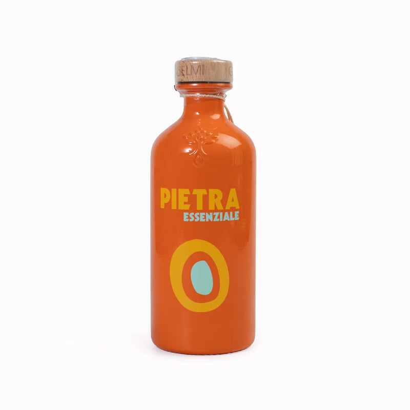 Orange bottle with 'Pietra Essenziale' branding on a white background