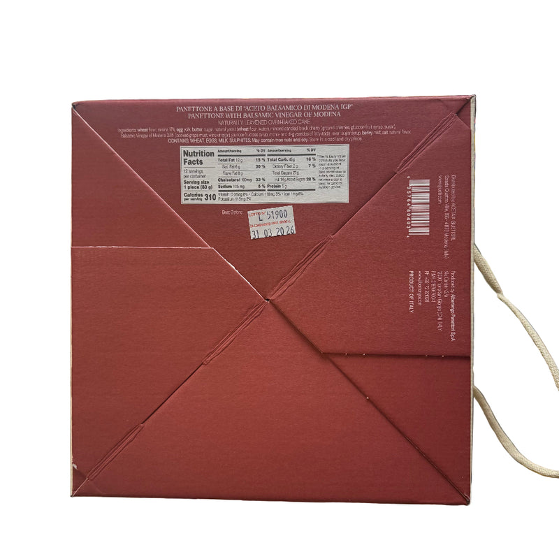 Close-up of a red box with text and a barcode, held in front of a store shelf.