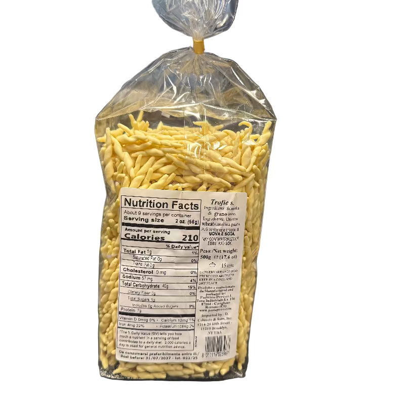 Packaged yellow noodles with a nutrition facts label on a desk.