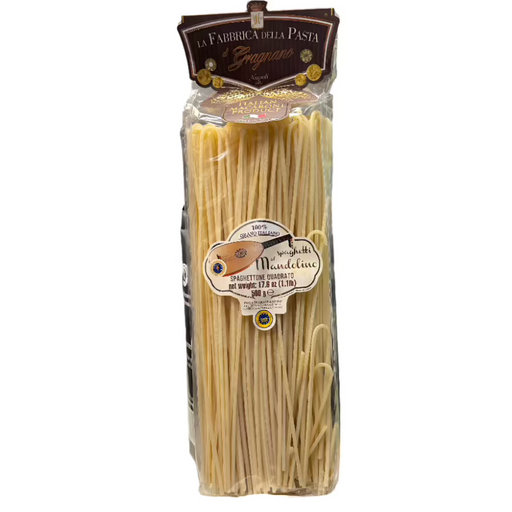 Packaged fresh spaghetti pasta squared-shaped, branded La Fabbrica Della Pasta, with a label indicating 'Mandolino' and a weight of 500g.