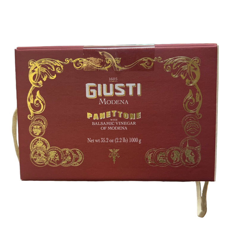 Red box of Giusti Modena Panettone with Balsamic Vinegar held in a store setting