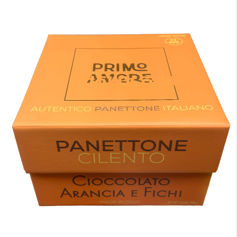 Orange box of Panettone Cilento with chocolate, orange, and figs held in a store setting.