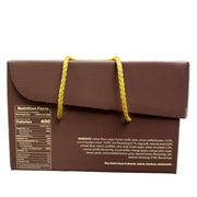 Brown box with yellow string held in a hand, with a blurred indoor background.