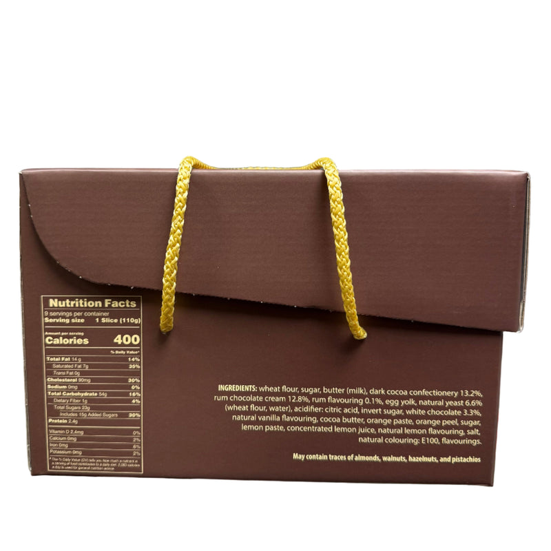 Brown box with yellow string held in a hand, with a blurred indoor background.