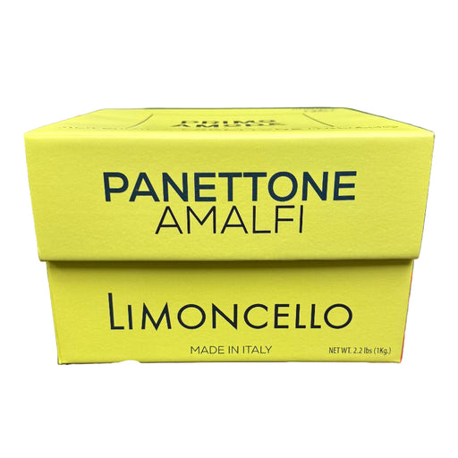 Yellow box of Panettone Amalfi Limoncello held in a hand with a store background.