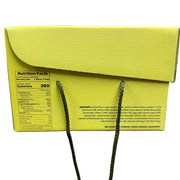 Yellow box with green strings held by a hand, showing nutrition facts label.