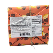 Hand holding a box of Vergani Panettone with pears and chocolate in a store setting