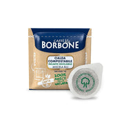 Packaging of Caffe Borbone Blue Blend Espresso Pods with one pod displayed in front, indicating round and balanced coffee with 100% compostable packaging.