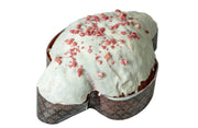 Bundt cake with white frosting and red berries on a marble surface