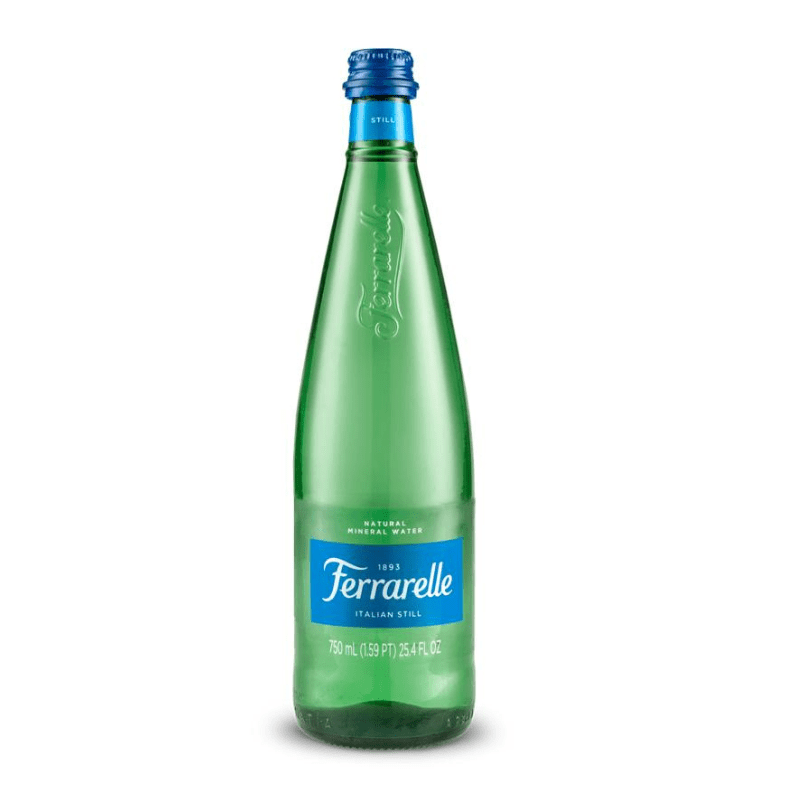 A green glass bottle of Ferrarelle Italian Natural Mineral Water with a blue label and blue cap, labeled 750 ml.