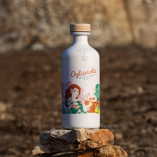 Bottle of Ogliarola olive oil on a stone surface with a natural background