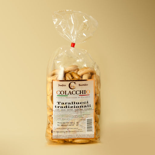 Packaged pasta with Colacchi branding on a beige background